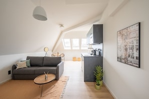 One-Bedroom Suite | Living area | 50-inch TV with cable channels