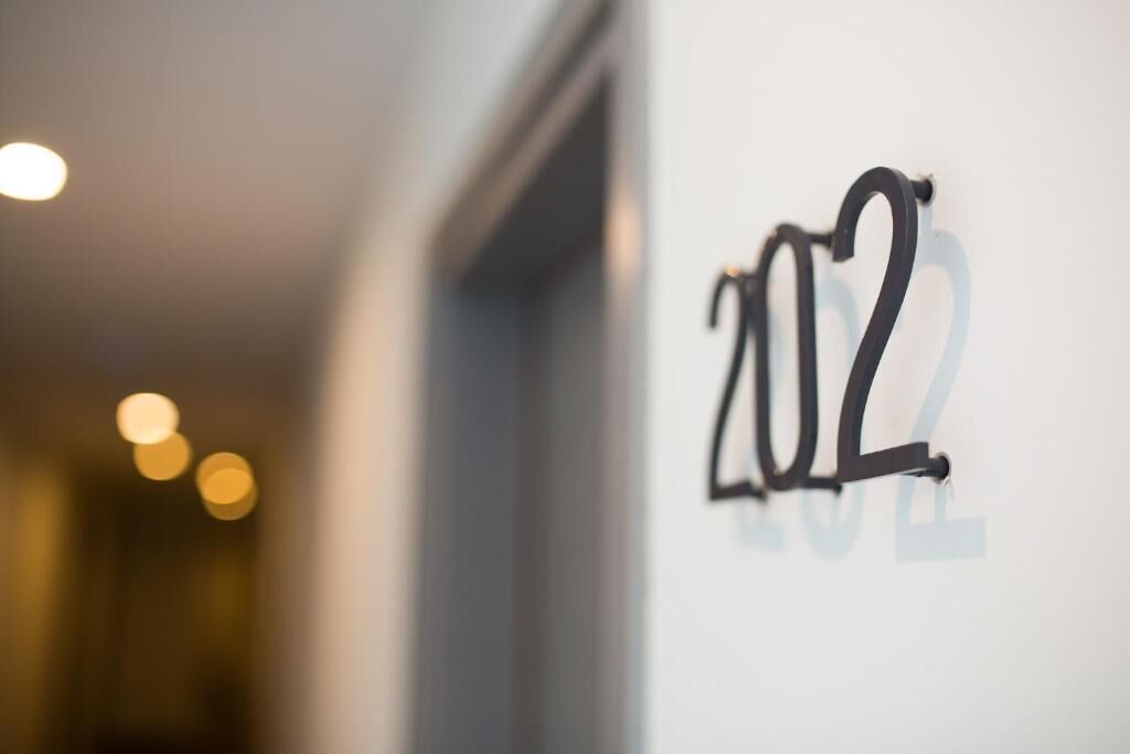 A close-up of a wall with the number '2022' in black letters.