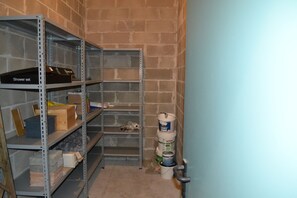 Storage area with metal shelving units and functional storage for essentials.