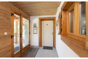 Stunning hallway with framed artwork and a heart-shaped door decoration, leading to a cozy space.