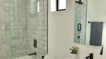 Bathtub, hair dryer, towels, shampoo