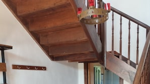 A staircase with wooden balusters and a patterned floor. - Former farm, very quiet location, lots of space (Libaros)