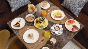 A breakfast table with various dishes, including toast, eggs, and fruit. - Borghese Contemporary Hotel (Rome)