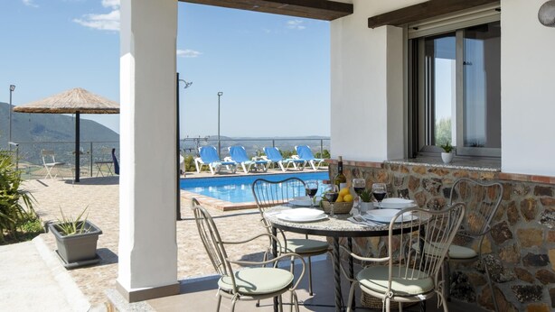 A terrace with a pool, outdoor seating, and a view of the sea. - El Granadino - Two Bedroom Villa, Sleeps 4 (El Gastor)
