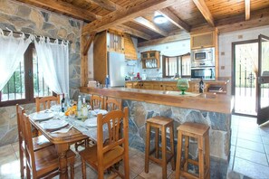 Enjoy meals in this cozy kitchen and dining area, complete with a refrigerator, microwave, and oven.