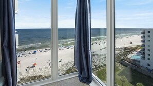 A view from a window overlooking a beach with umbrellas and a pool area. - The 9th Floor Offers A True Blue View Of The Sparkling Gulf Of Mexico! (pensacola)