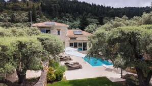 A stone villa with a swimming pool, surrounded by trees and a hilly landscape. - Eratito - Three Bedroom Villa, Sleeps 6 (Tsoukalades)
