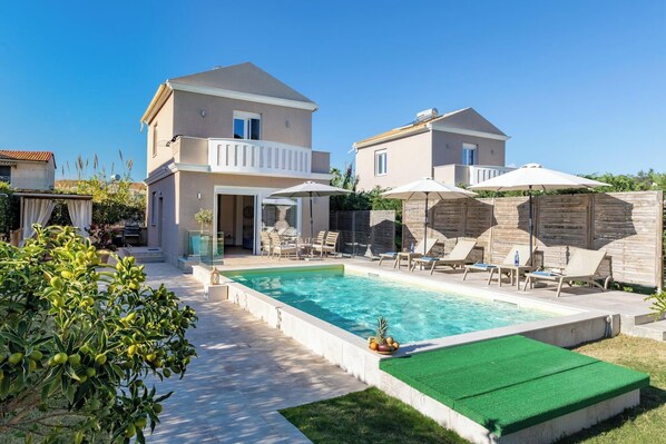 A two-story house with a swimming pool, outdoor seating, and a garden. - Erato - Two Bedroom Villa, Sleeps 4 (Agios Georgios)