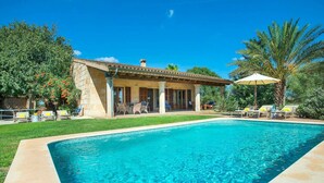 A swimming pool with a patio area, a stone building, and surrounding greenery. - Sa Rota Nova - Three Bedroom Villa, Sleeps 6 (Mallorca)