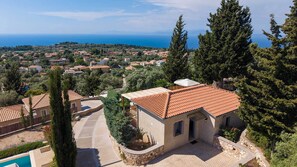 Una propiedad residencial con piscina, patio y vista al mar.