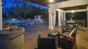 An outdoor patio with a pool, lounge chairs, and a dining area. - Ca'n Puput - Two Bedroom Villa, Sleeps 4 (Mallorca)