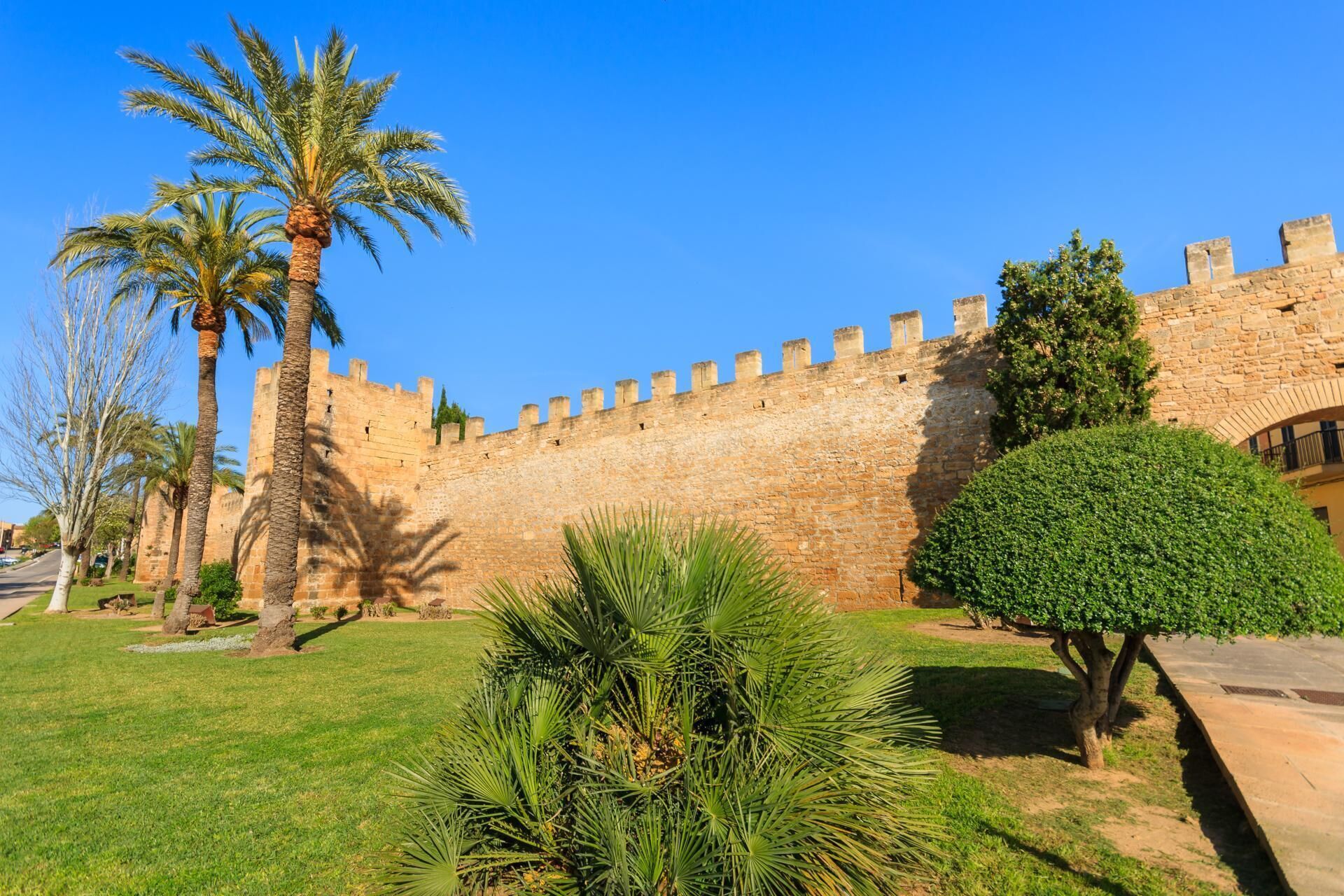 A historic stone wall with a clear sky.