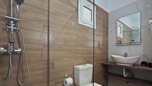 A modern bathroom with a glass shower enclosure, a toilet, a sink, and a mirror. - Sun Mare - Three Bedroom Villa, Sleeps 6 (Corfu)