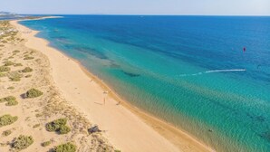 An aerial view of a beach with clear turquoise waters, sandy shores, and sparse vegetation. - Sun Mare - Three Bedroom Villa, Sleeps 6 (Corfu)