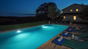 A swimming pool with lounge chairs and a table, surrounded by a house and trees. - Villa La Plaine - Four Bedroom Villa, Sleeps 8 (Monclar-de-Quercy)
