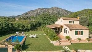 A two-story house with a swimming pool, surrounded by a well-maintained lawn and potted plants. - Ca'n Paner - One Bedroom Villa, Sleeps 2 (Mallorca)