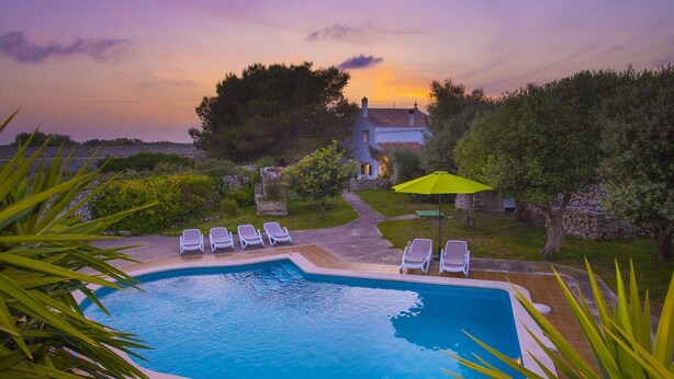 A rectangular swimming pool with a tiled edge, surrounded by a stone pathway. - Talati de Dalt - Five Bedroom Villa, Sleeps 8 (Alaior)