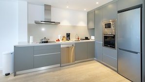 A modern kitchen with grey cabinetry, a stainless steel refrigerator, a built-in oven, and a dishwasher. - Pine Walk Apartment - Three Bedroom Villa, Sleeps 5 (Mallorca)