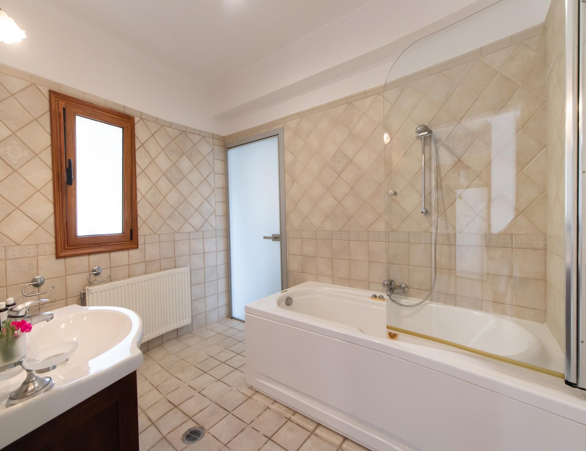 Een moderne badkamer met een bad, een wastafel en een spiegel.