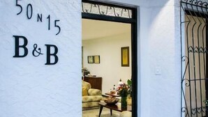 A building entrance with a sign reading "50 N15 B&B" and a doorway leading inside. - 50N15 B&B (Cali)