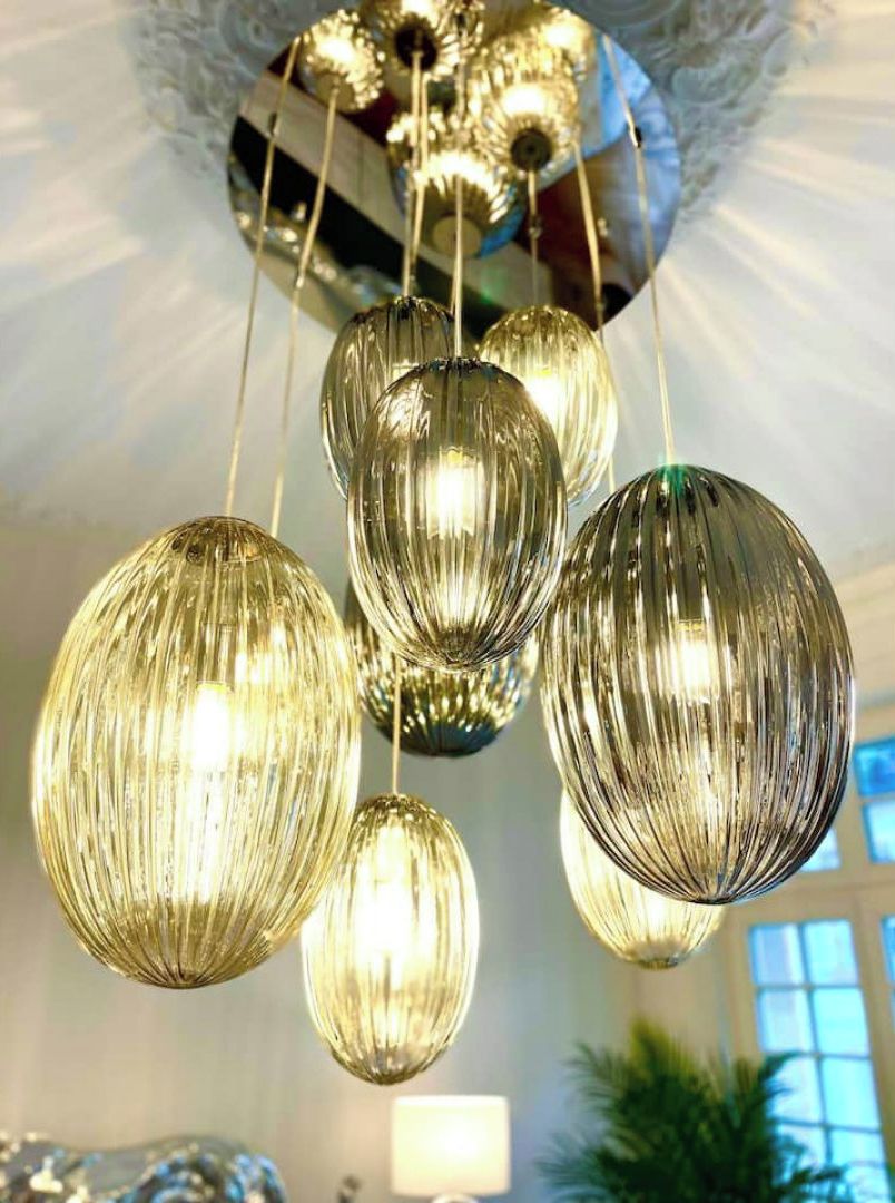 Een kroonluchter met meerdere bolvormige glazen lampen, hangend aan het plafond.