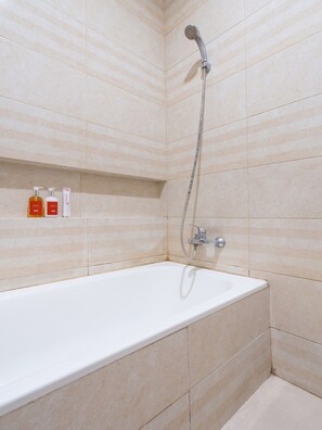 Habitación estándar doble | Baño | Ducha, cabezal de ducha tipo lluvia, toallas y papel higiénico