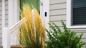 A house with a green door, white siding, and a number 6036 on the door. - Cozy townhome (Billings)