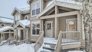 A multi-story wooden house with a covered porch and steps leading to the entrance. - 2-BD 3-BDR Ski Cabin (Silverthorne)