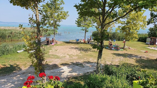 Guests can enjoy serene lakeside views and tranquil surroundings amidst lush greenery and trees.