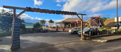 A restaurant entrance with a signboard listing menu items and a reception area.