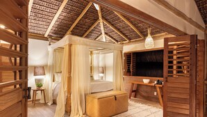 A cozy bedroom with a four-poster bed, a wooden chest, and a large mirror. - Sempre Vivo (Tibau do Sul)