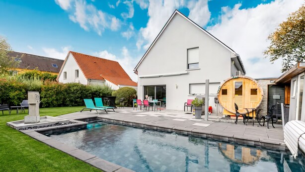 A residential property with a swimming pool, outdoor seating, and a sauna. - Private heated pool and jacuzzi villa (Furdenheim)