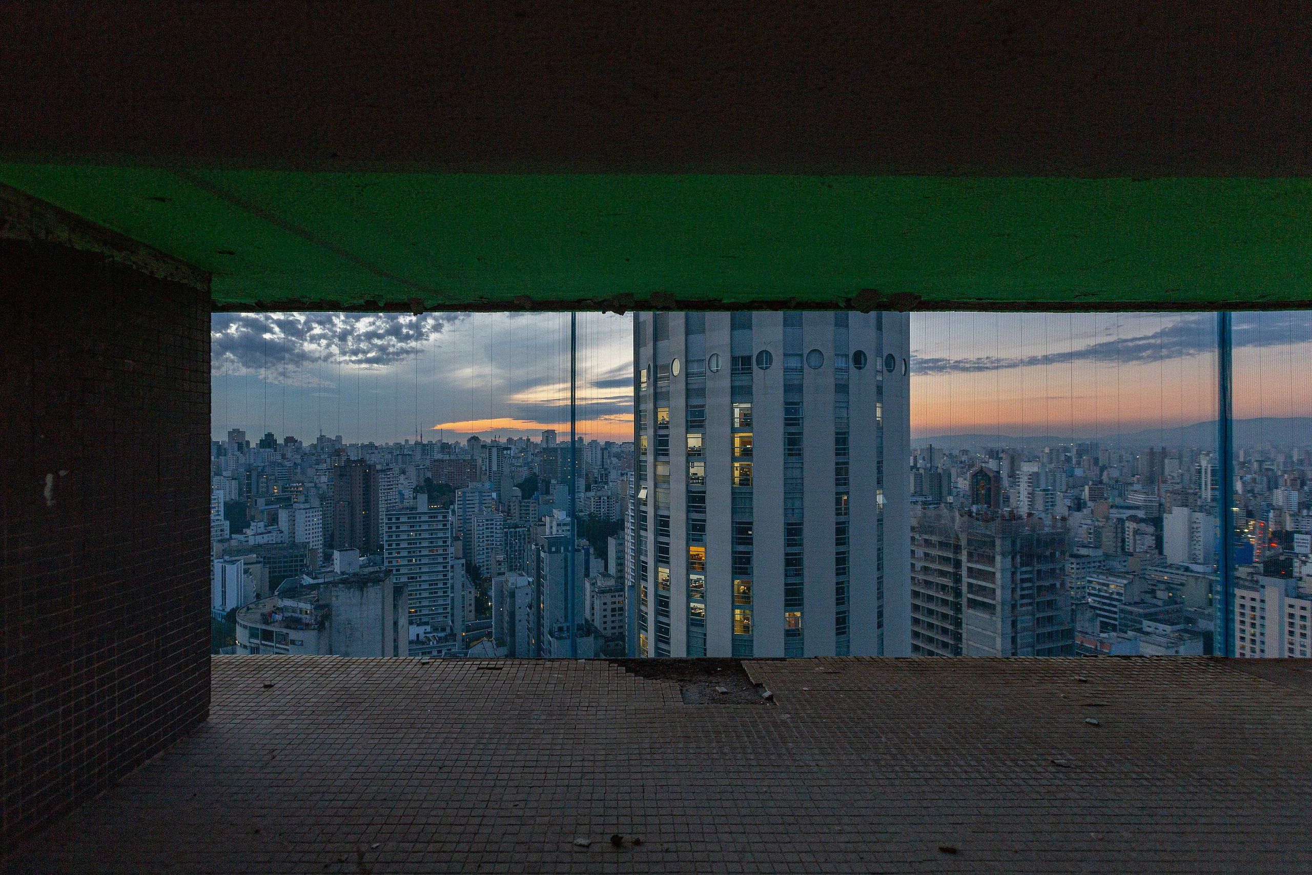 A high-rise building with a view of a cityscape.