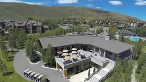 A resort with a pool, outdoor seating, and a mountainous backdrop. - Sun Valley Adventure Condo (Sun Valley)