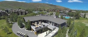 Ein Resort mit Pool, Sitzgelegenheiten im Freien und einer Bergkulisse.