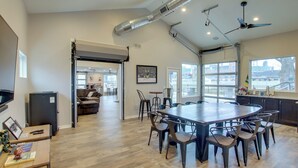 A spacious kitchen with a large island, modern appliances, and ample natural light from large windows. - Green Bay Getaway Near Lambeau Field & Resch! (Green Bay)