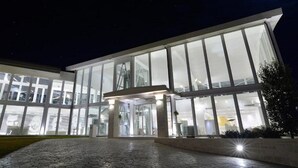 A modern building with large glass windows and a central entrance area. - Insula Alba Resort and Spa - Adults Only (Hersonissos)