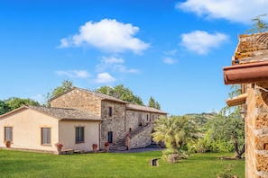A stone building with a tiled roof, a staircase leading to the entrance, and a well-maintained lawn. - Casale Montemoro Private Pool & Garden Sleeps 10 (Allerona)