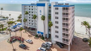 A hotel with a modern design, located near a beach with a parking lot in front. - ~fantastic Gulf Front Condo North Of The Pier~ 2 Bedroom Condo by RedAwning (Fort Myers Beach)