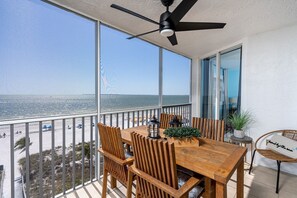 Outdoor dining - Spectacular Gulf Front Corner Unit 2 Bedroom Condo by RedAwning (Fort Myers Beach)