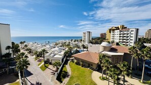 A resort with multiple buildings, palm trees, and a view of the ocean. - Beautiful 2 Bedroom Condo on the Sea of Cortez at Las Palmas Resort D-501 2 Condo by RedAwning (Puerto Peñasco)