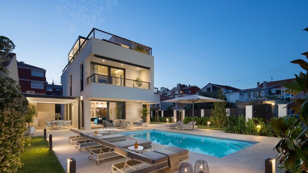 A modern two-story house with a swimming pool, outdoor seating, and a well-lit patio area. - Villa Tereza (Zadar)