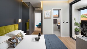 A modern bedroom with a bed, a laptop, and a large window. - Villa Tereza (Zadar)