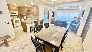 A spacious kitchen with a dining area, a large island, and a view of the ocean. - Spectacular 2 Bedroom Condo on Sandy Beach at Las Palmas Resort G-201 2 Condo by RedAwning (Puerto Peñasco)