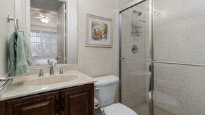 A bathroom with a sink, toilet, and glass-enclosed shower. - ~the Bonita Paddle Efficiency~ Your Home Away From Home In Paradise 1 Bedroom Condo by RedAwning (Bonita Springs)