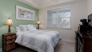 A bedroom with a bed, two bedside tables with lamps, a framed picture on the wall, and a window with blinds. - ~the Bonita Paddle Efficiency~ Your Home Away From Home In Paradise 1 Bedroom Condo by RedAwning (Bonita Springs)
