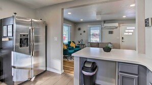 A modern kitchen with a stainless steel refrigerator, a built-in water dispenser, and a white countertop. - Grand Junction Vacation Rental w/ Fire Pit! (Grand Junction)