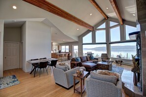 Relax in a spacious living area with a large dining table, comfortable seating, and a fireplace.
