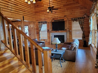 Country estate log cabin, elevated wrap around porch. Live Oak, Cypress and Pine