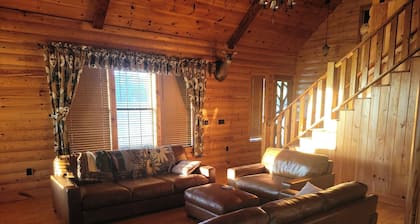 Country estate log cabin, elevated wrap around porch. Live Oak, Cypress and Pine
